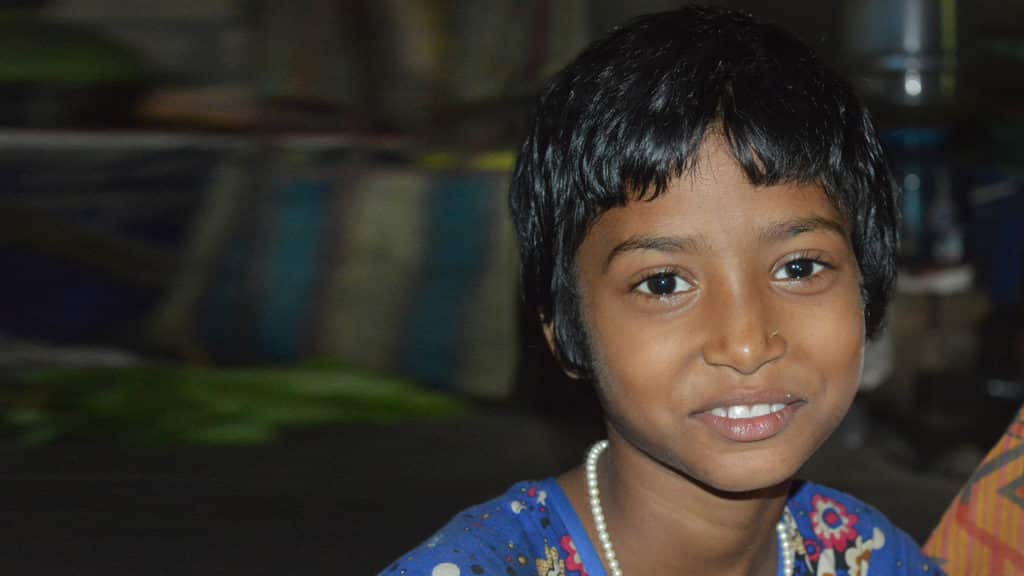 A young girl smiling.