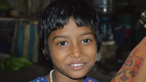 A young girl smiling.