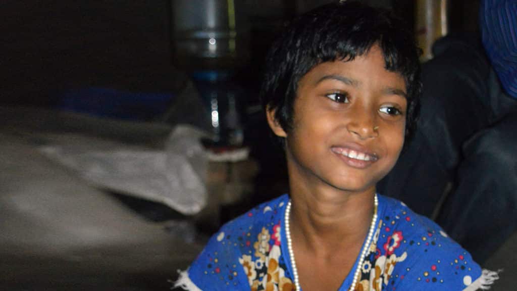 A young girl smiling.