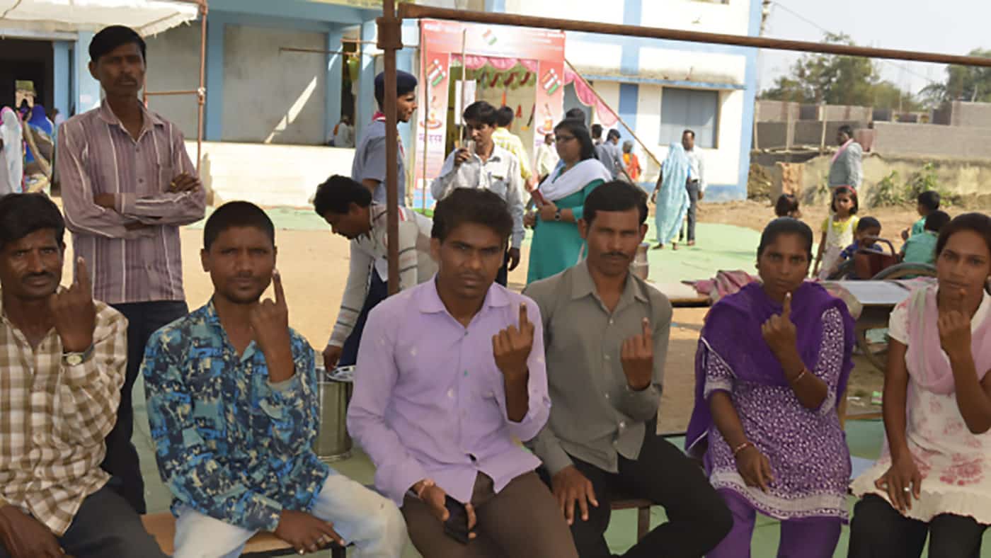 People with disability showing the voting mark on their fingers.