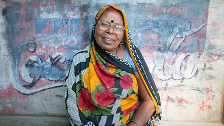 A lady sitting smiling.