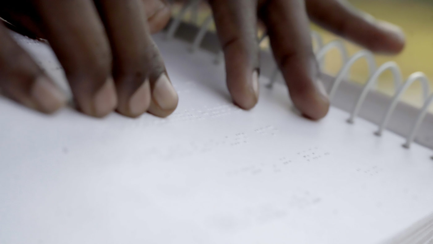 Hands using braille.