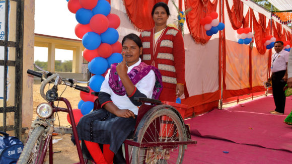 Two women smile to camera.